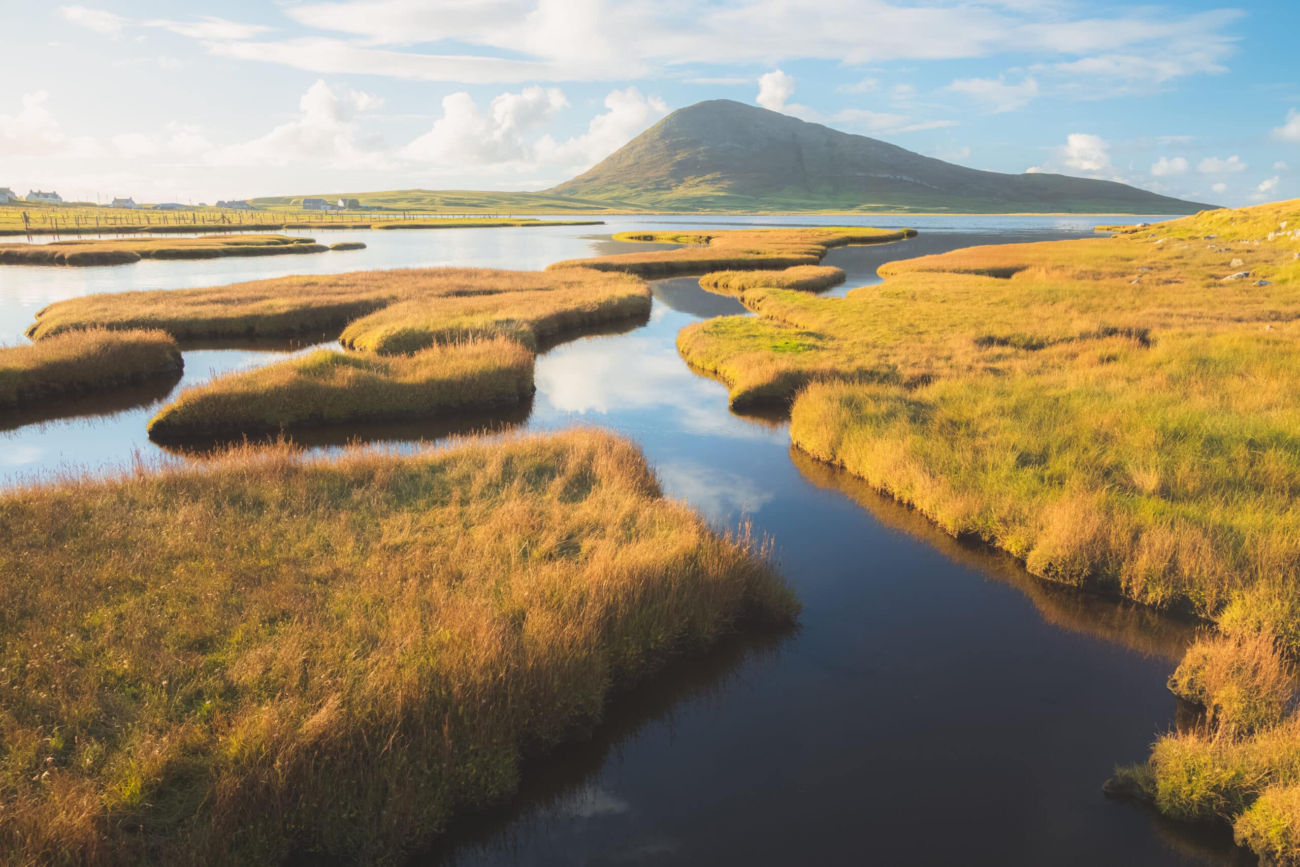 golden light on the salt marsh mountain landscape at Northton on the Isle of Lewis and Harris on the Outer Hebrides, Scotland, UK.